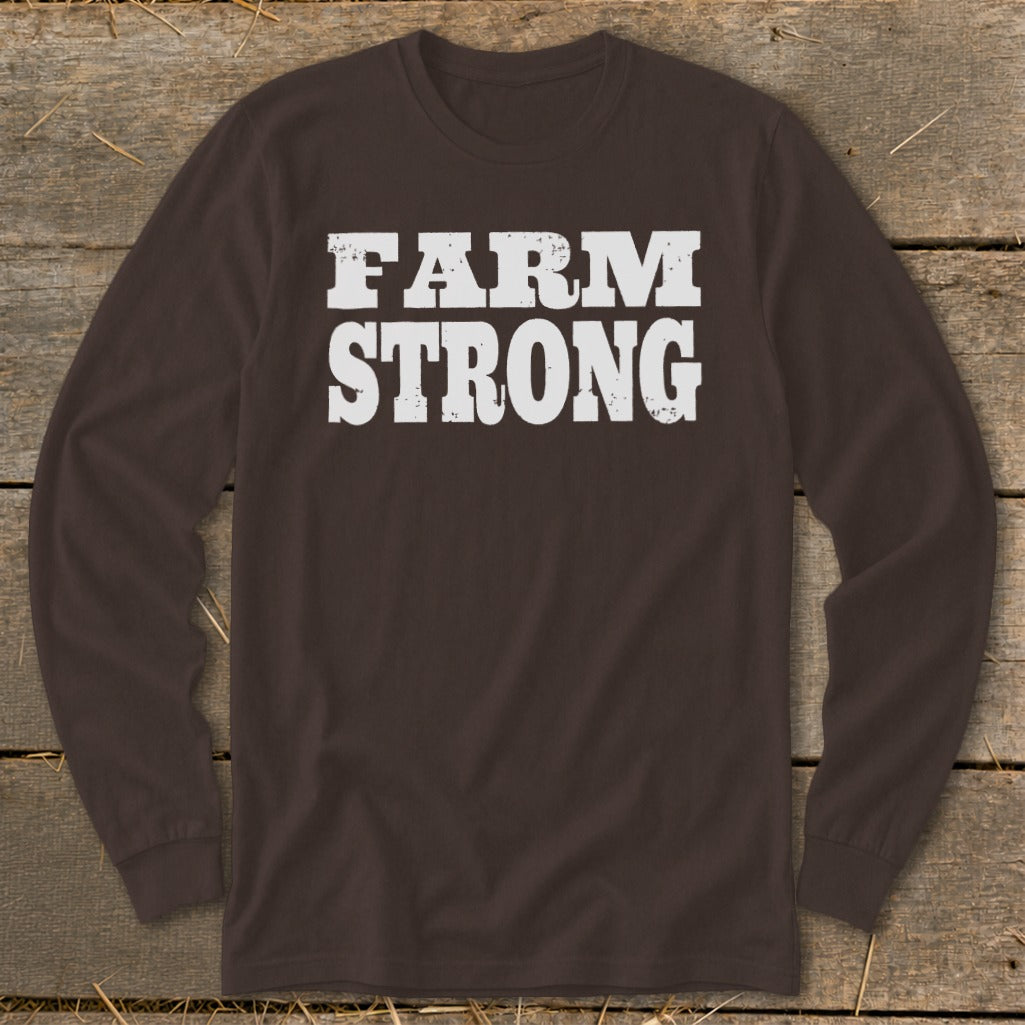 Dark brown long-sleeve t-shirt with distressed white text reading FARM STRONG displayed across the chest.