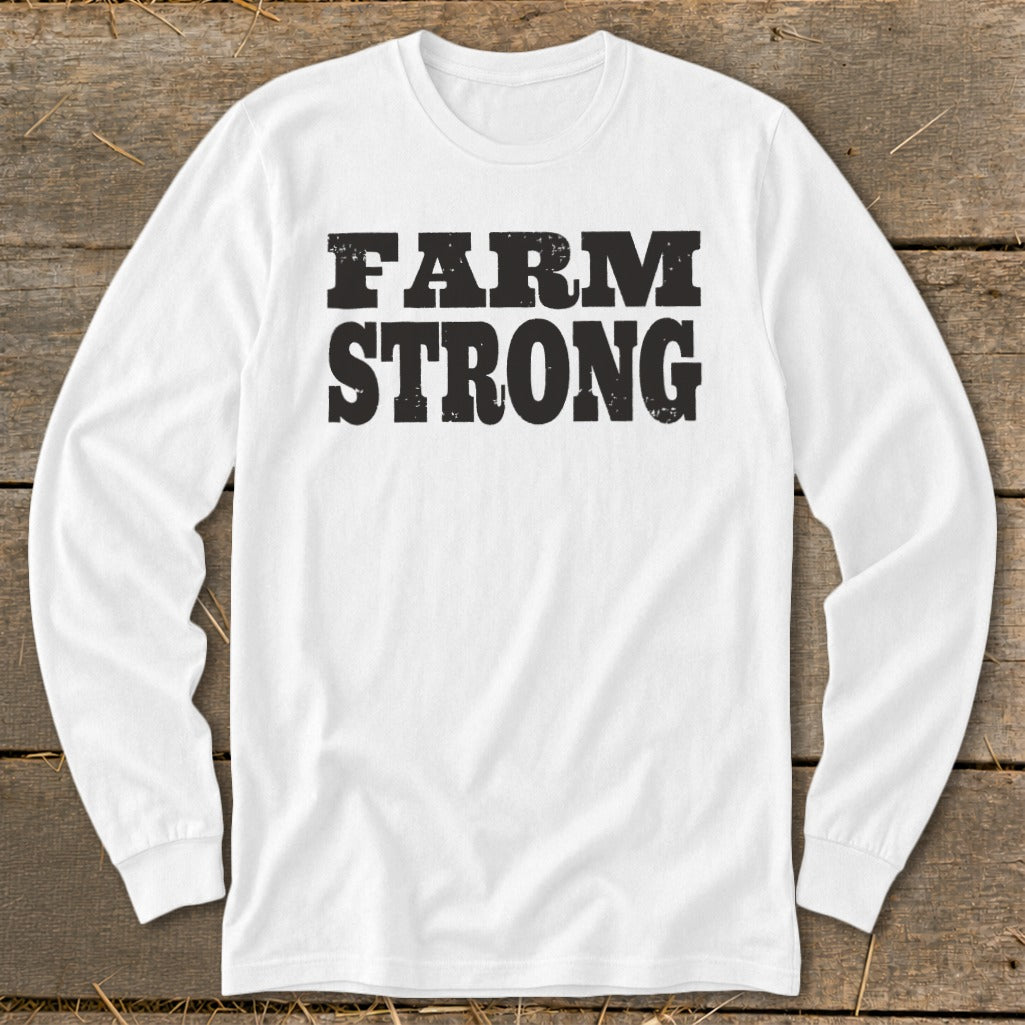A white long-sleeved t-shirt with the words "FARM STRONG" printed in bold, distressed black letters on the chest.