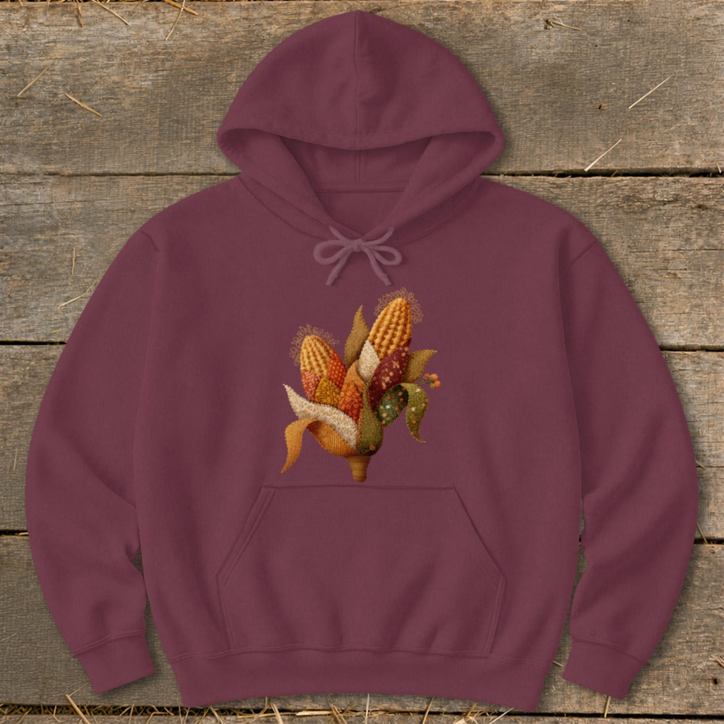 Burgundy hoodie with an embroidered cornucopia of colorful corn ears and leaves.
