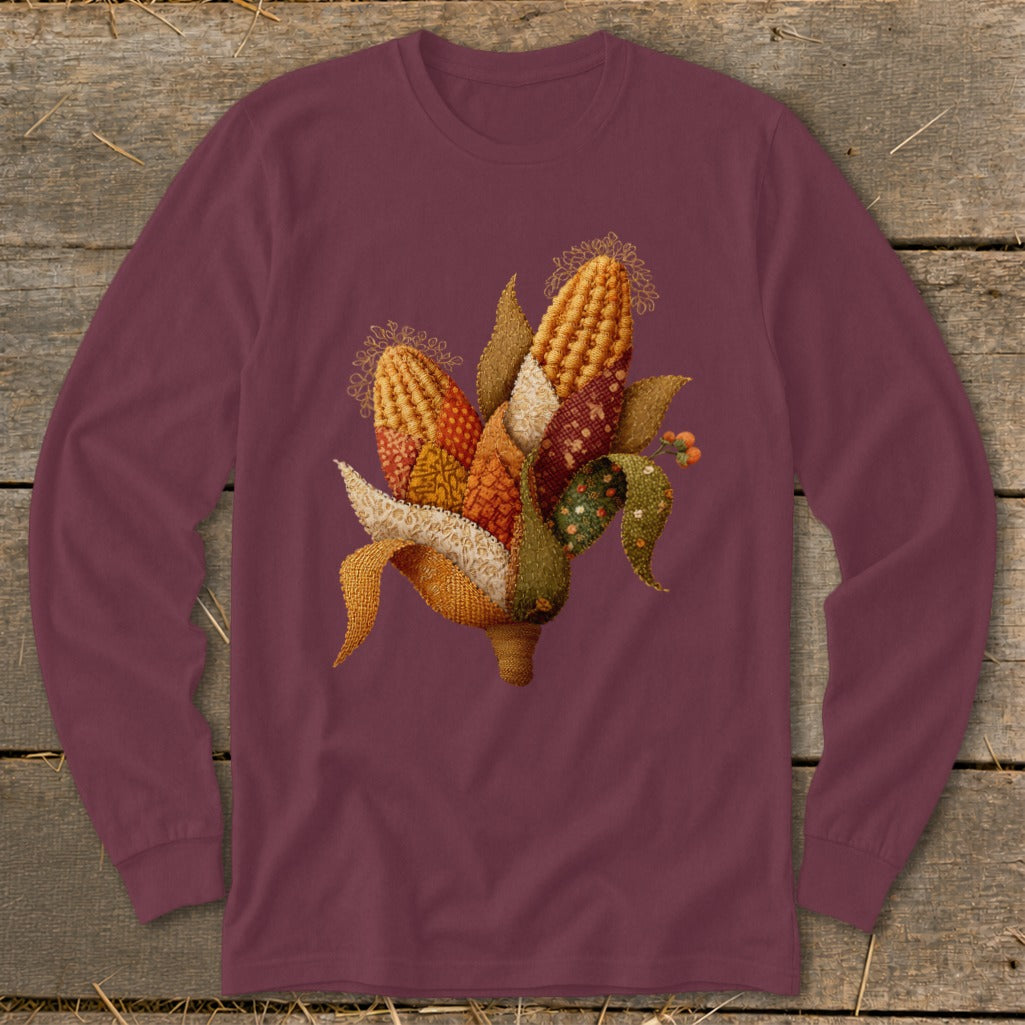 Maroon long-sleeve shirt with a colorful corn cob illustration featuring patchwork fabric textures.