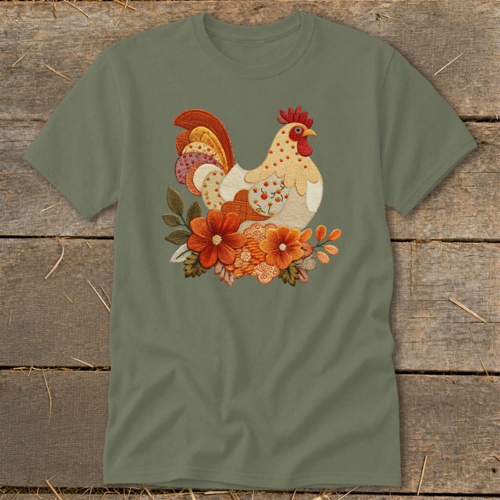 An olive green t-shirt featuring an embroidered rooster surrounded by autumn flowers.