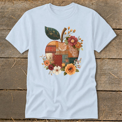 Light blue t-shirt with a quilted apple design and floral accents.