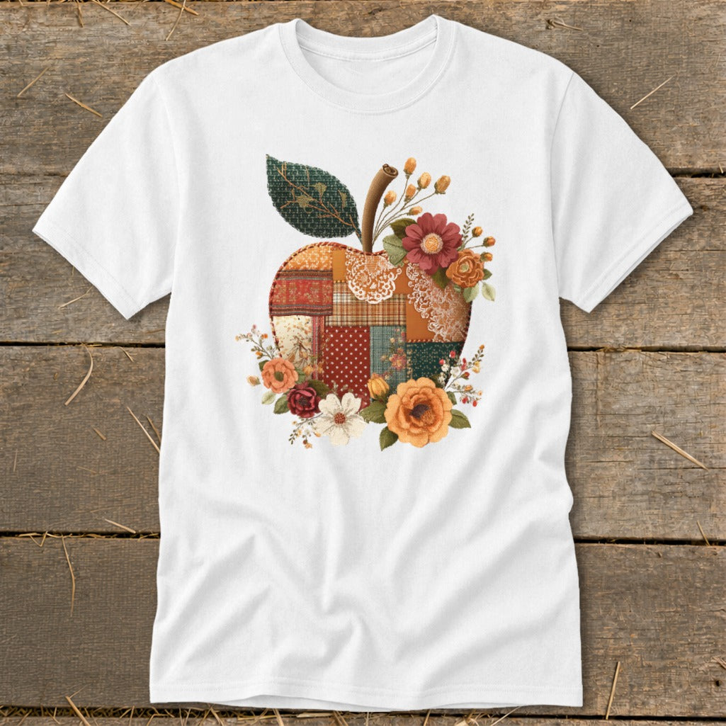White t-shirt with a patchwork apple graphic adorned with fall flowers.