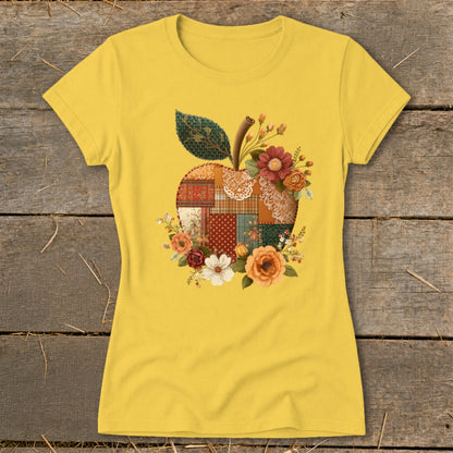 Yellow t-shirt with a patchwork apple design surrounded by flowers.