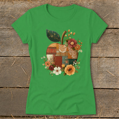 Green t-shirt with a patchwork apple graphic surrounded by flowers.