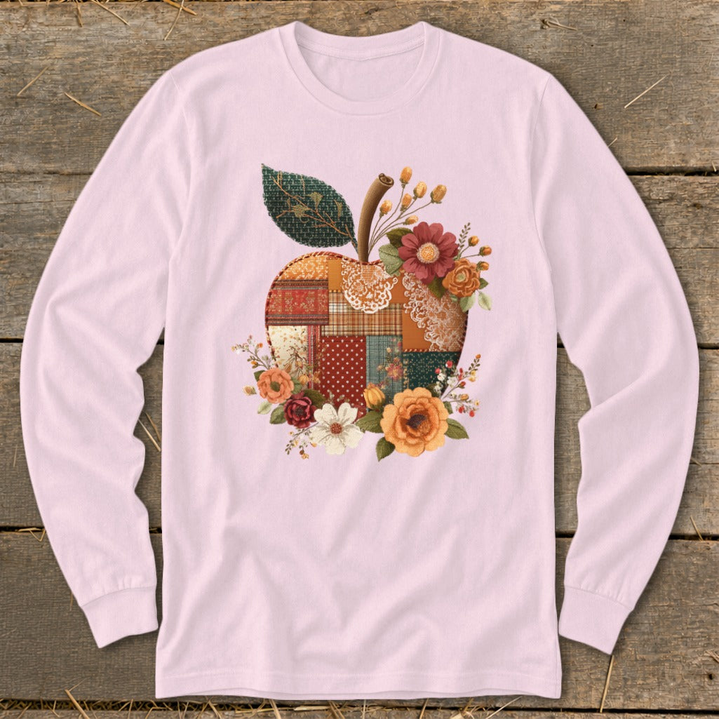 Long sleeve pink t-shirt with a patchwork apple graphic surrounded by flowers.