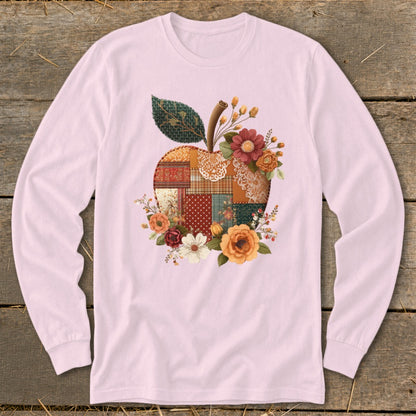 Long sleeve pink t-shirt with a patchwork apple graphic surrounded by flowers.