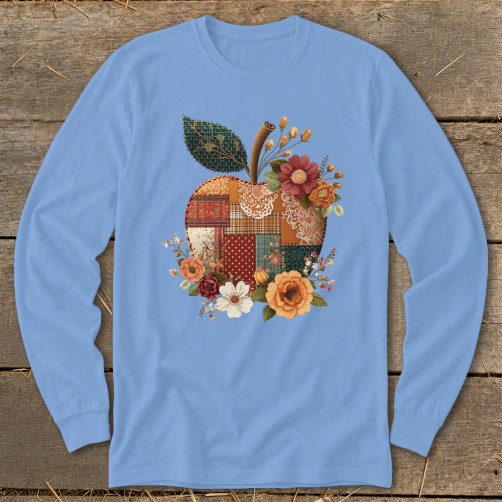Light blue long-sleeve shirt featuring a patchwork apple design with flowers.