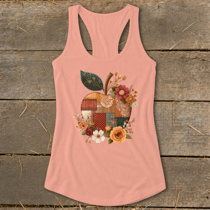 Peach tank top with a patchwork apple design surrounded by flowers.