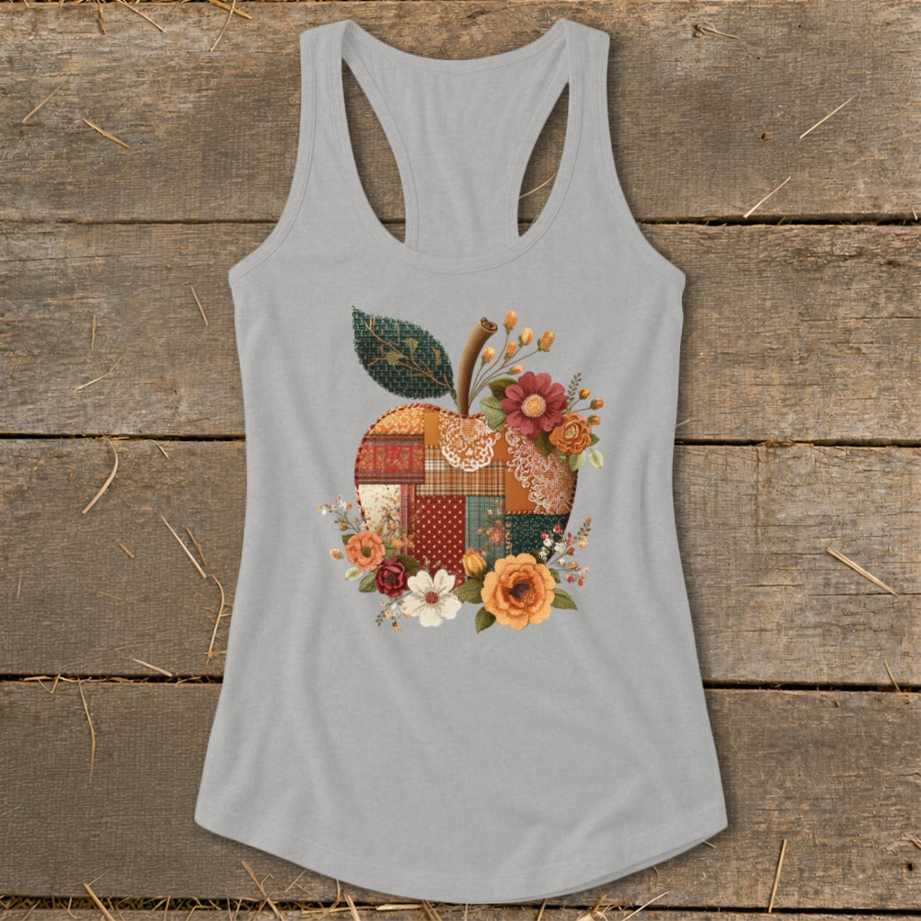 Grey tank top with a patchwork apple design surrounded by flowers.