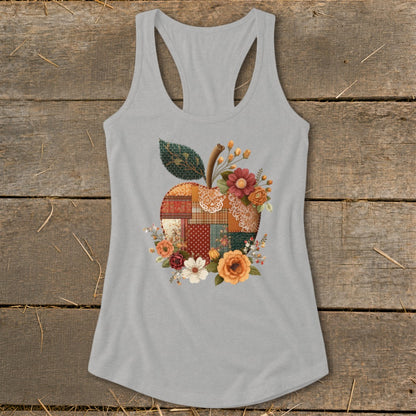 Grey tank top with a patchwork apple design surrounded by flowers.