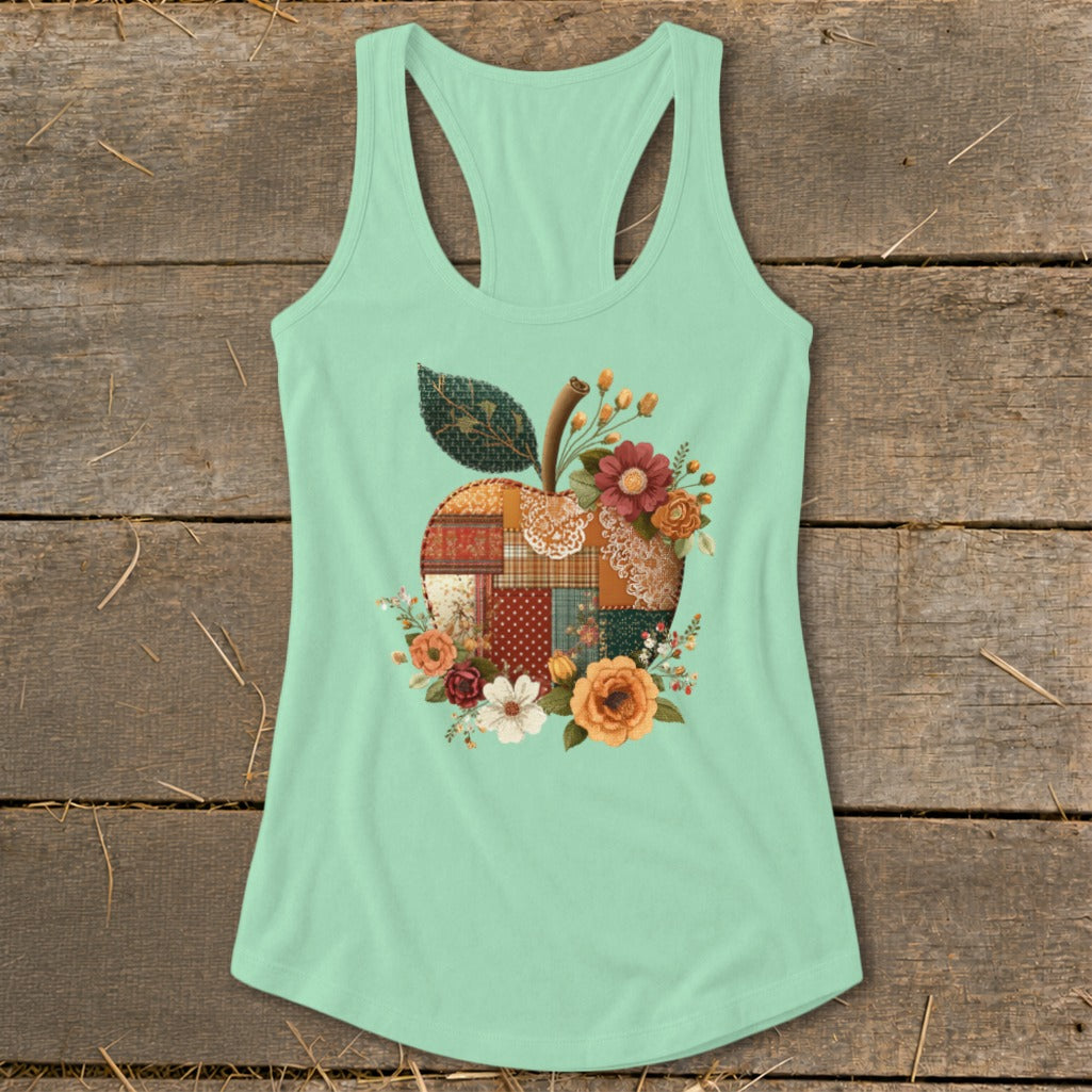 Mint green tank top with a patchwork apple design and floral accents.