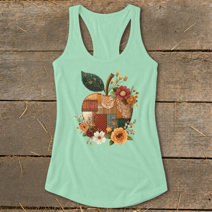 Mint green tank top with a patchwork apple design and floral accents.