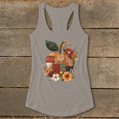 Grey tank top with a patchwork apple design and floral accents.