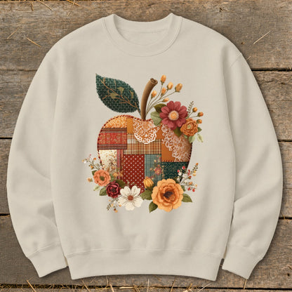 Crewneck sweatshirt with a quilted apple and floral design.