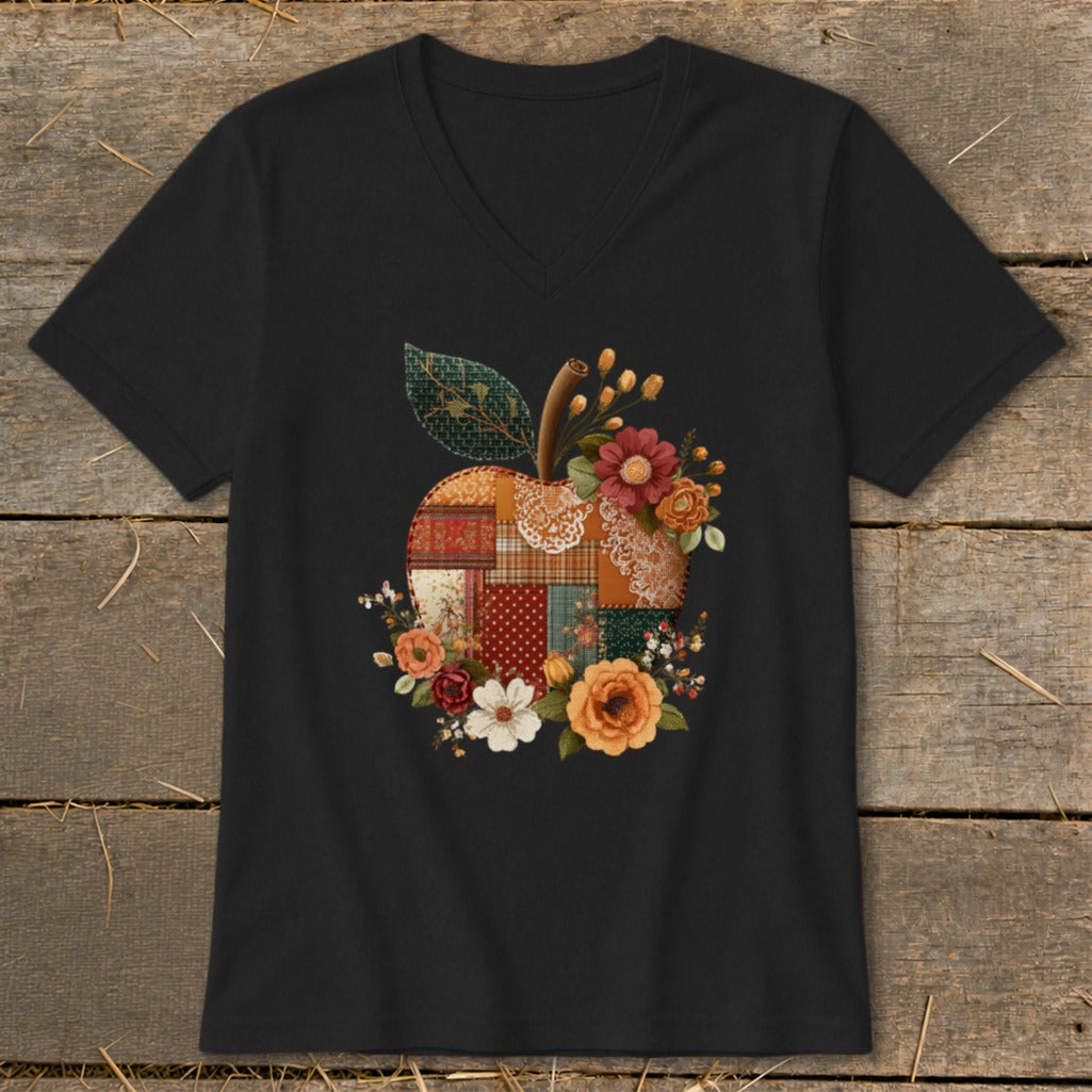 Black t-shirt with a patchwork apple design and floral accents.
