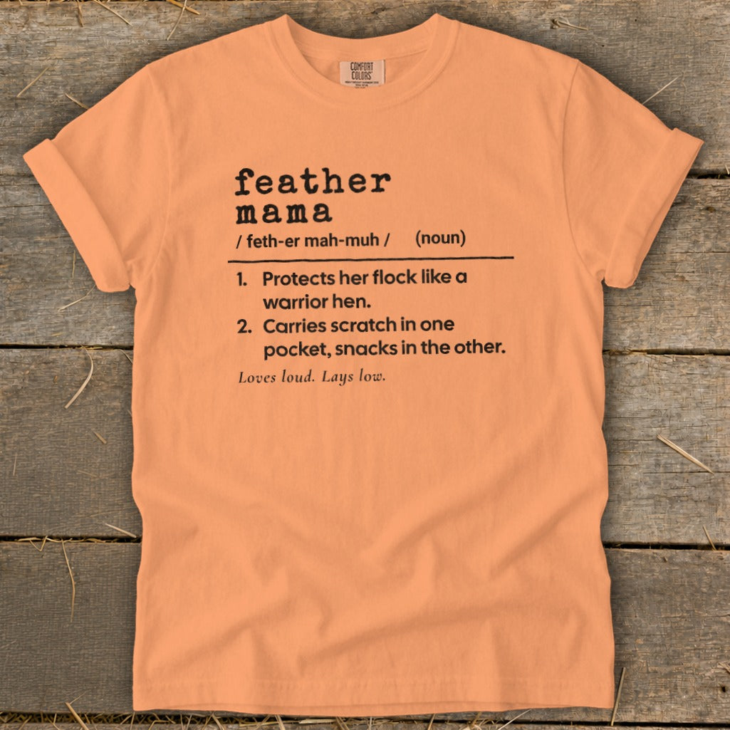 Orange t-shirt with "feather mama" definition and phrases: "Loves loud. Lays low."