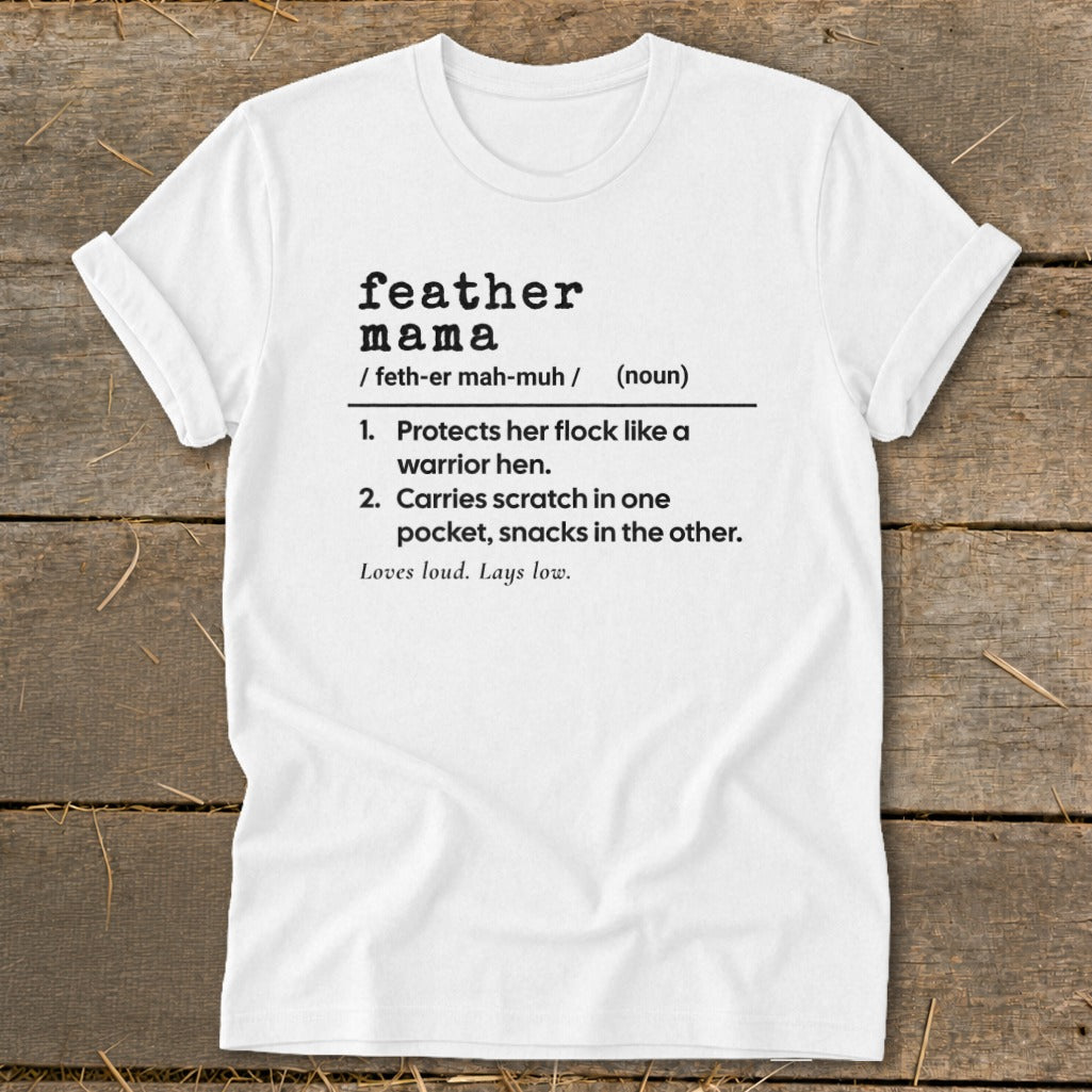 White t-shirt with "feather mama" definition: "Protects her flock like a warrior hen. Carries scratch in one pocket, snacks in the other."