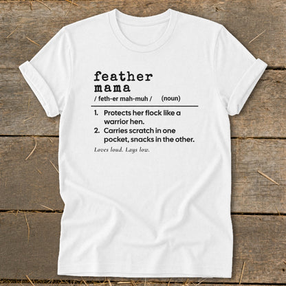 White t-shirt with "feather mama" definition: "Protects her flock like a warrior hen. Carries scratch in one pocket, snacks in the other."