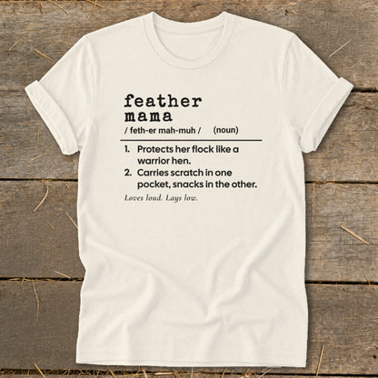 Cream t-shirt with "feather mama" definition printed in black text.