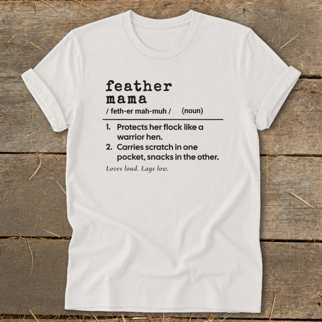 White t-shirt with "feather mama" definition: Protects flock, carries snacks.