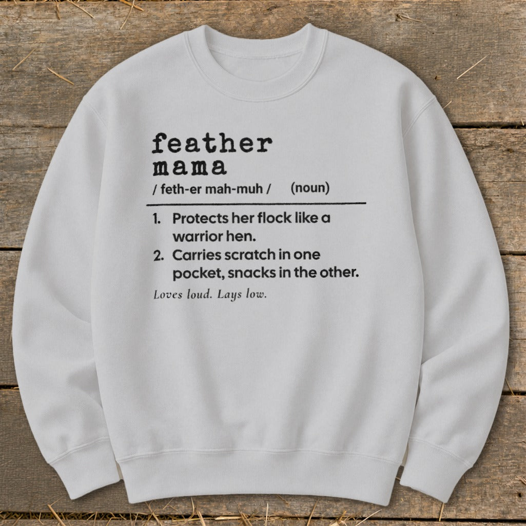 Sweatshirt with black text defining "feather mama" and its characteristics.