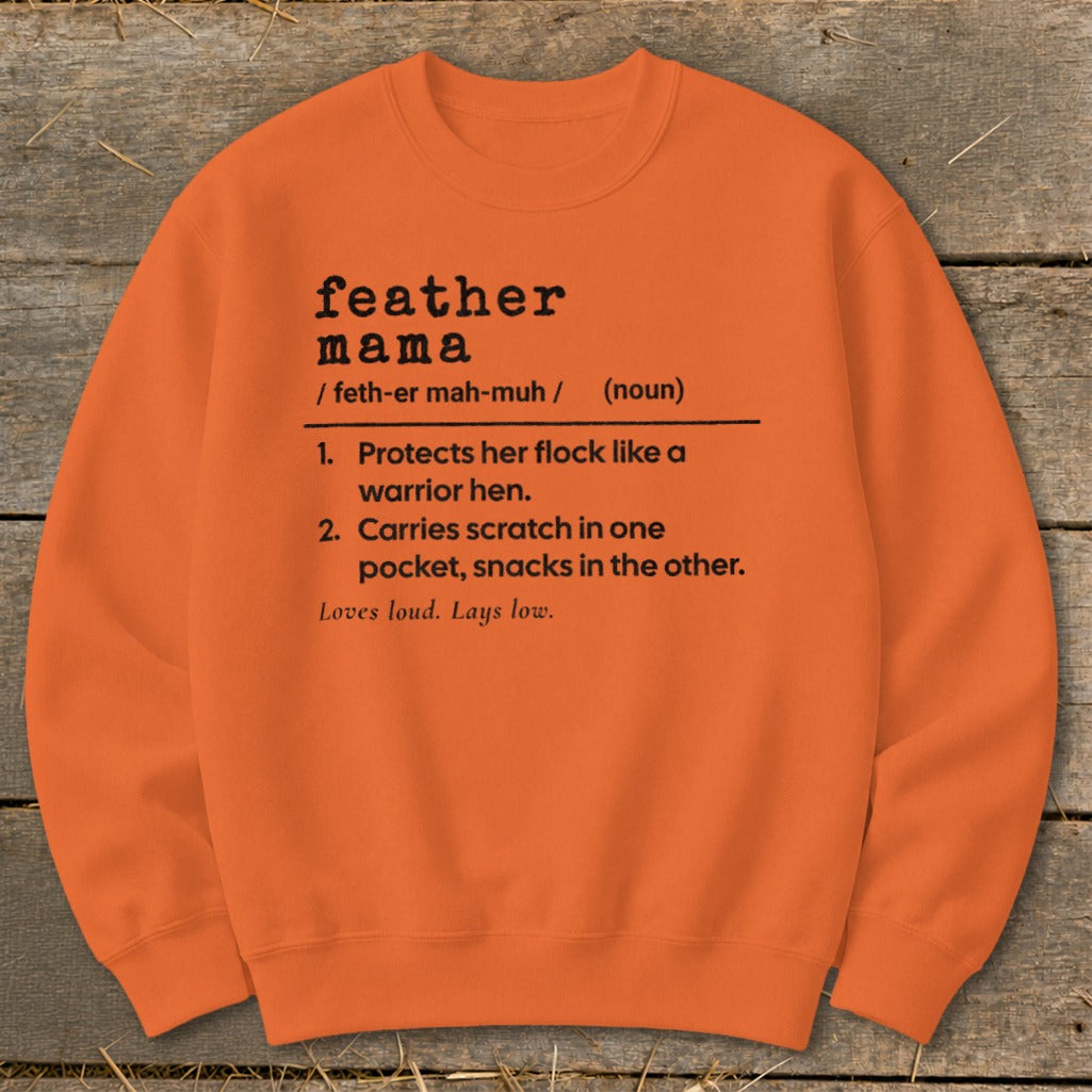 Orange sweatshirt with black text defining "feather mama".