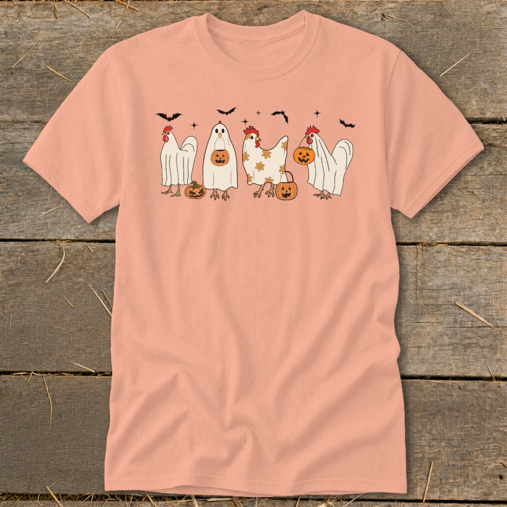 Peach t-shirt with Halloween chickens dressed as ghosts carrying pumpkins and bats.