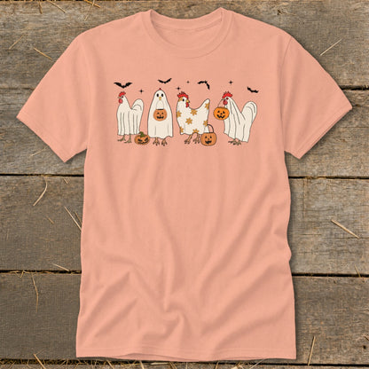 Peach t-shirt with Halloween chickens dressed as ghosts carrying pumpkins and bats.