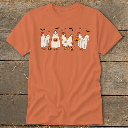 Chickens in ghost costumes holding pumpkins with bats above.