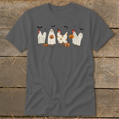 Four chickens dressed in Halloween costumes, two as ghosts, one as a decorated chicken, and one with a pumpkin bucket.
