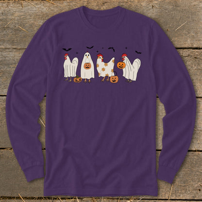 Chickens dressed as ghosts with pumpkins and bats on purple shirt.