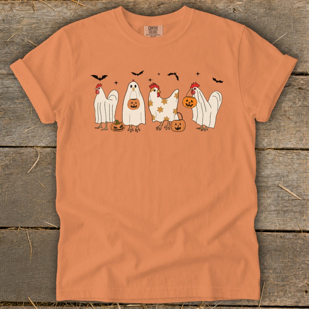 Orange t-shirt with chickens dressed as ghosts and pumpkins for Halloween.