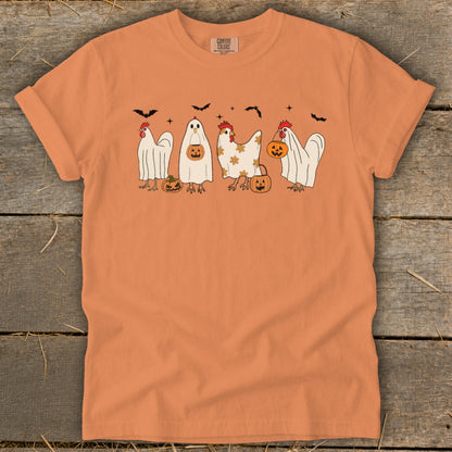 Orange t-shirt with chickens dressed as ghosts and pumpkins for Halloween.