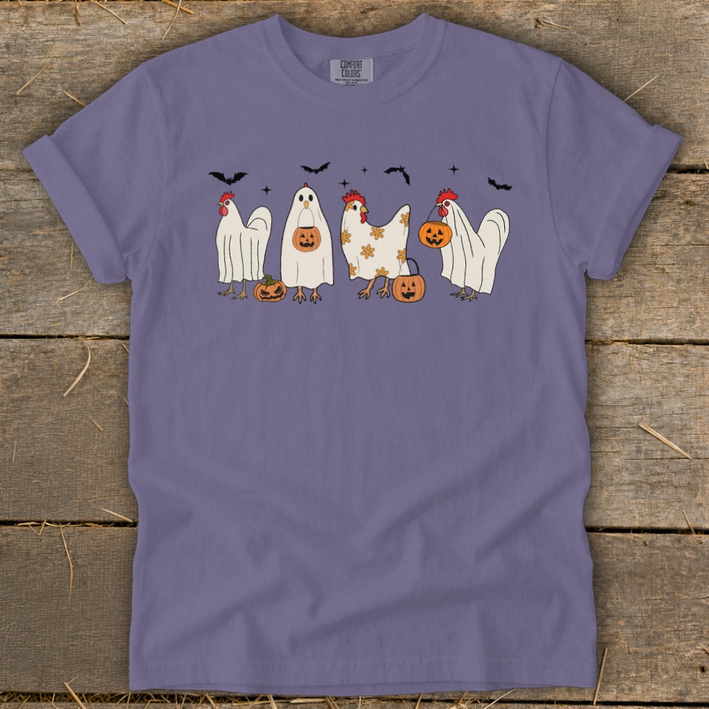Purple t-shirt with Halloween-themed chickens and pumpkins graphic and bats above.