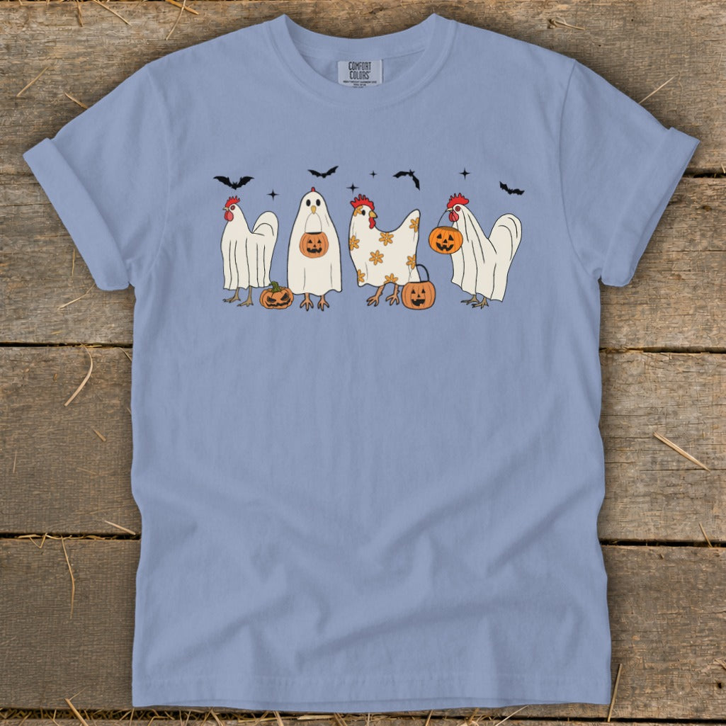 Light blue t-shirt with cartoon chickens in ghost costumes and pumpkins for Halloween.