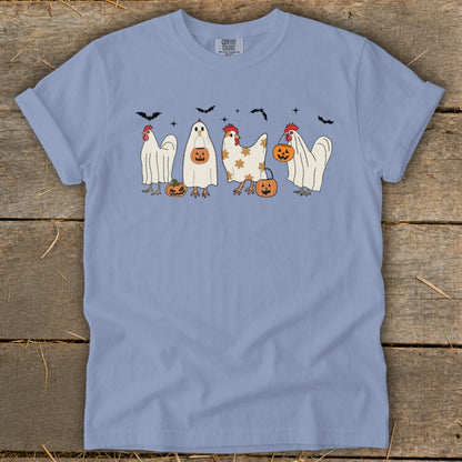 Light blue t-shirt with cartoon chickens in ghost costumes and pumpkins for Halloween.