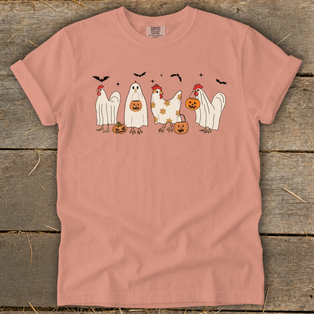 Peach t-shirt with Halloween chickens dressed as ghosts holding pumpkins and bats.
