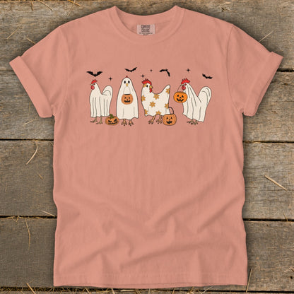 Peach t-shirt with Halloween chickens dressed as ghosts holding pumpkins and bats.