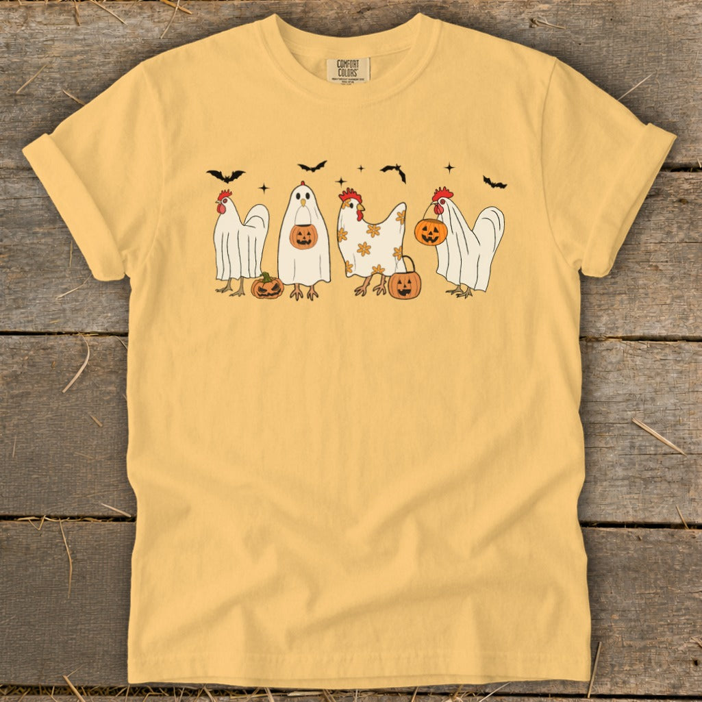 Yellow t-shirt with graphic of chickens dressed as ghosts with pumpkins and bats.
