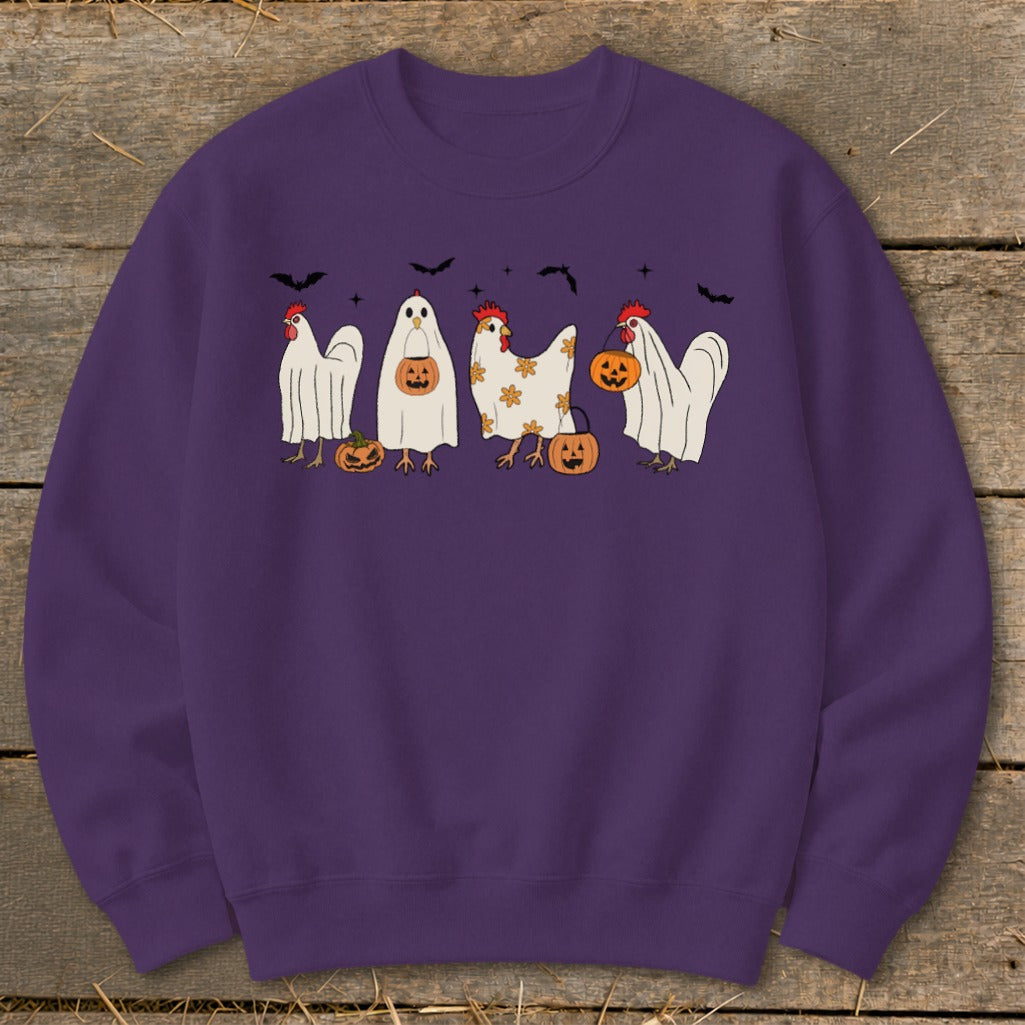 Four chickens in Halloween costumes trick-or-treating with pumpkins and bats.