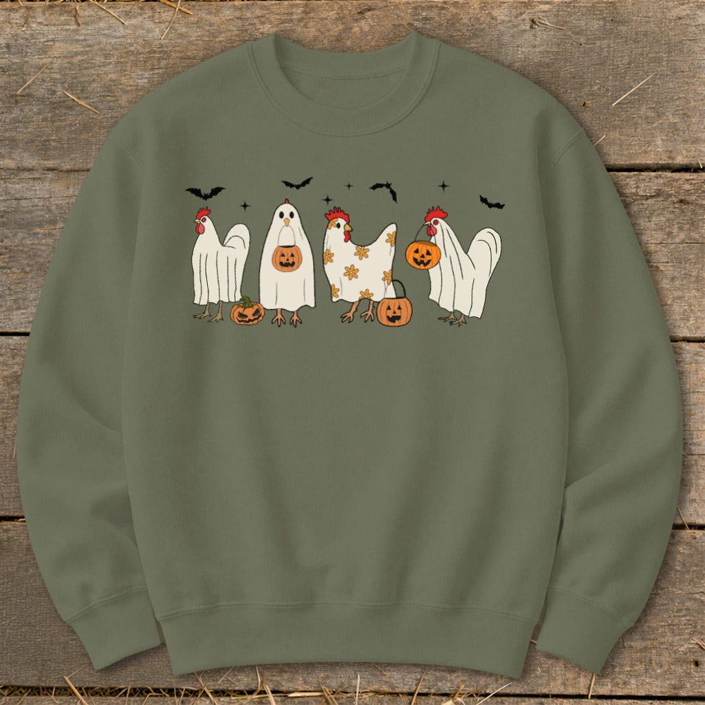 Four chickens in Halloween costumes with pumpkins and bats.