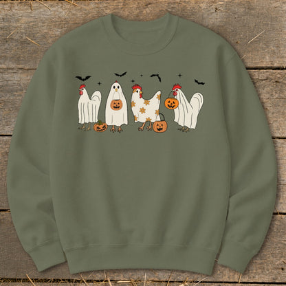 Four chickens in Halloween costumes with pumpkins and bats.