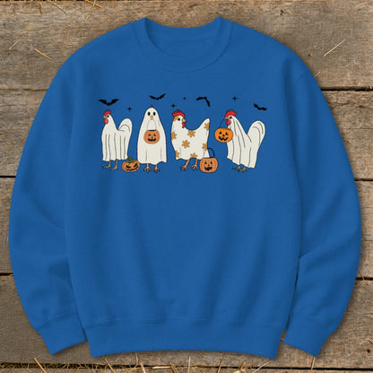 Four chickens in Halloween costumes, two as ghosts, one dressed as pumpkin, and one plain, with bats.