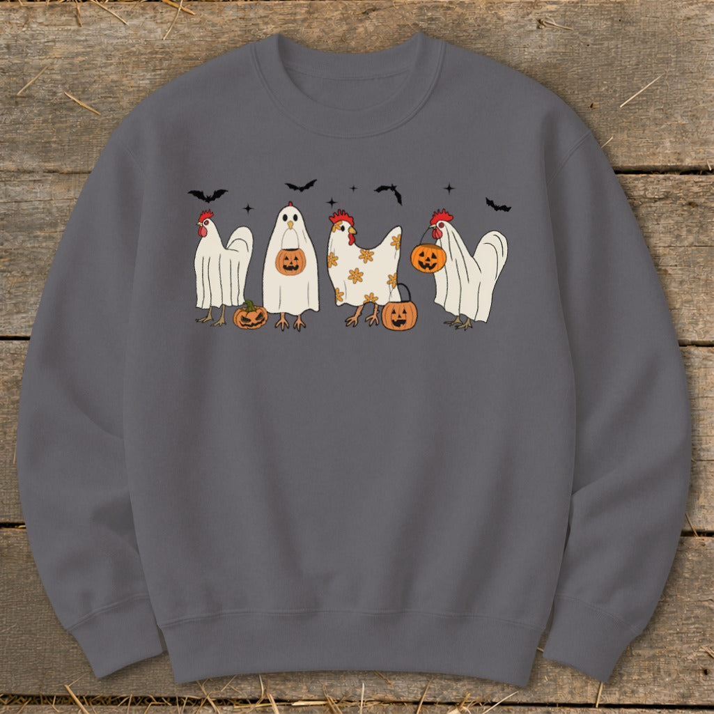 Four chickens dressed as ghosts with pumpkins and bats in a Halloween theme.