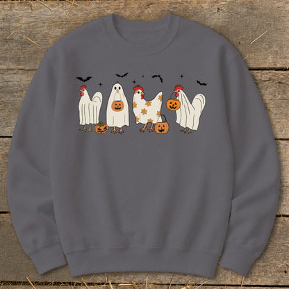 Four chickens dressed as ghosts with pumpkins and bats in a Halloween theme.