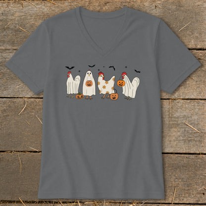 Halloween chickens dressed as ghosts holding pumpkins with bats overhead.