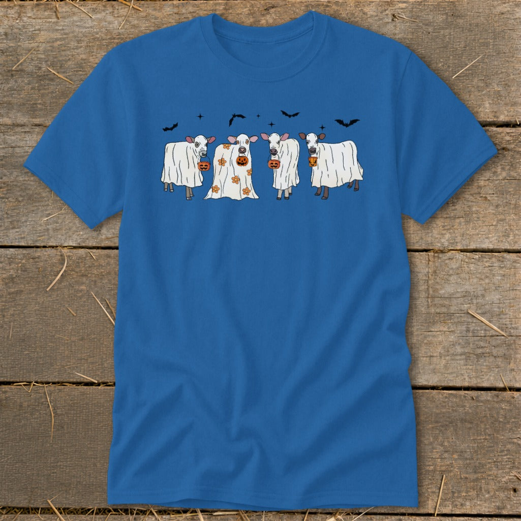 Cute cows dressed as ghosts with pumpkins and bats for Halloween.