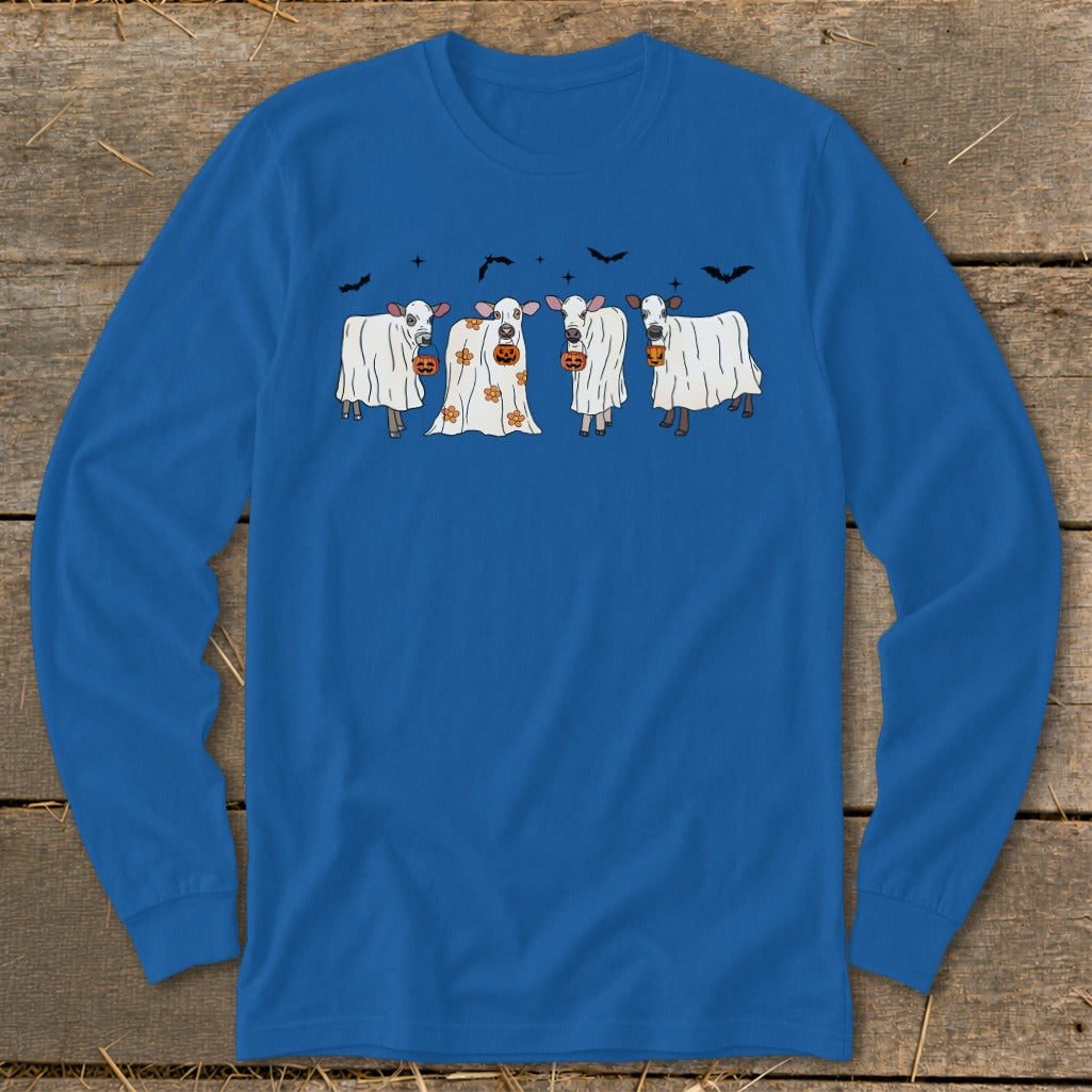 Four cows dressed as ghosts hold pumpkins under bats and stars.
