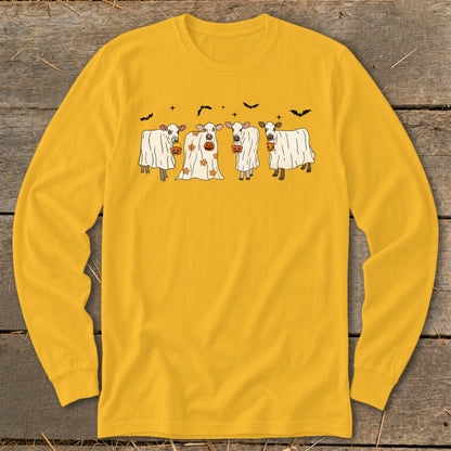 Four cows dressed as ghosts hold jack-o'-lanterns with bats and stars.